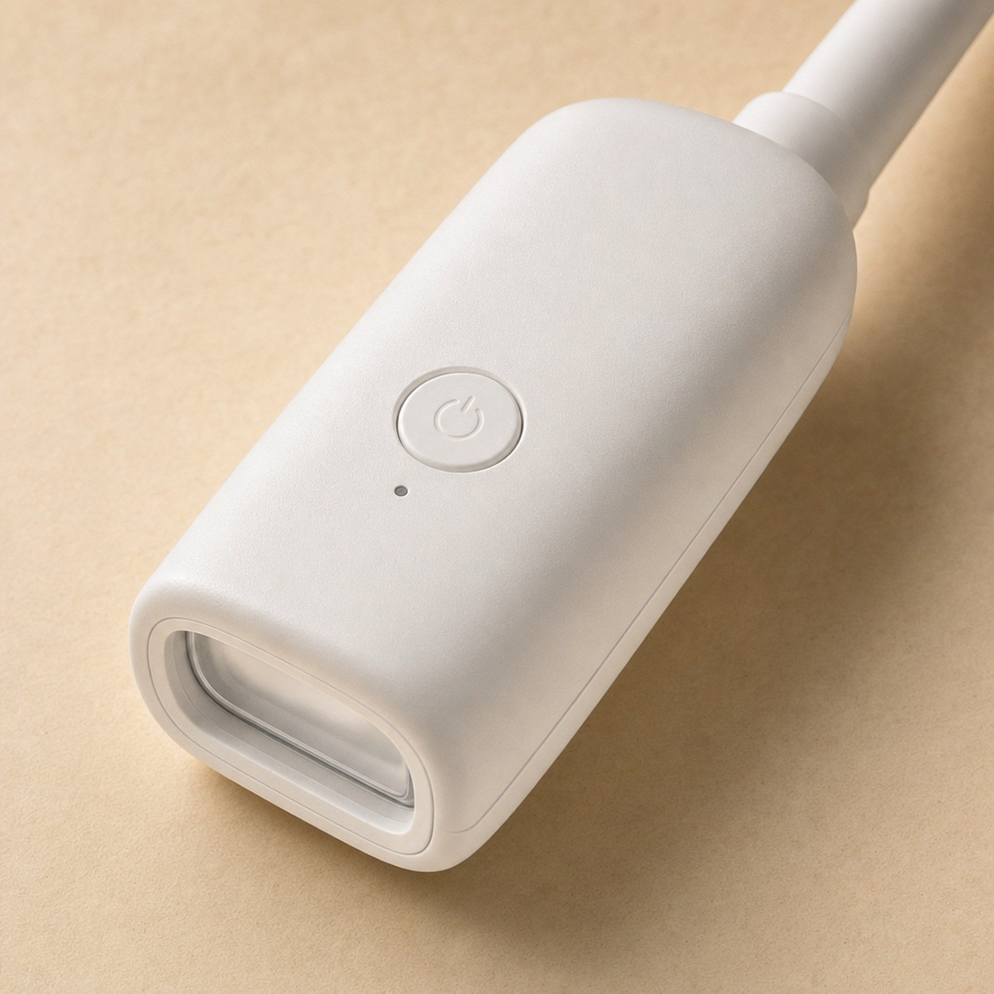 Close-up of a GlimGlow lamp head showing its single control button and LED lens